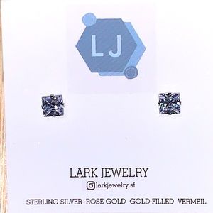 Princess cut cubic zirconia on a four prong sterling silver setting.